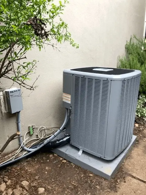 A&S technician installing a residential AC condenser unit