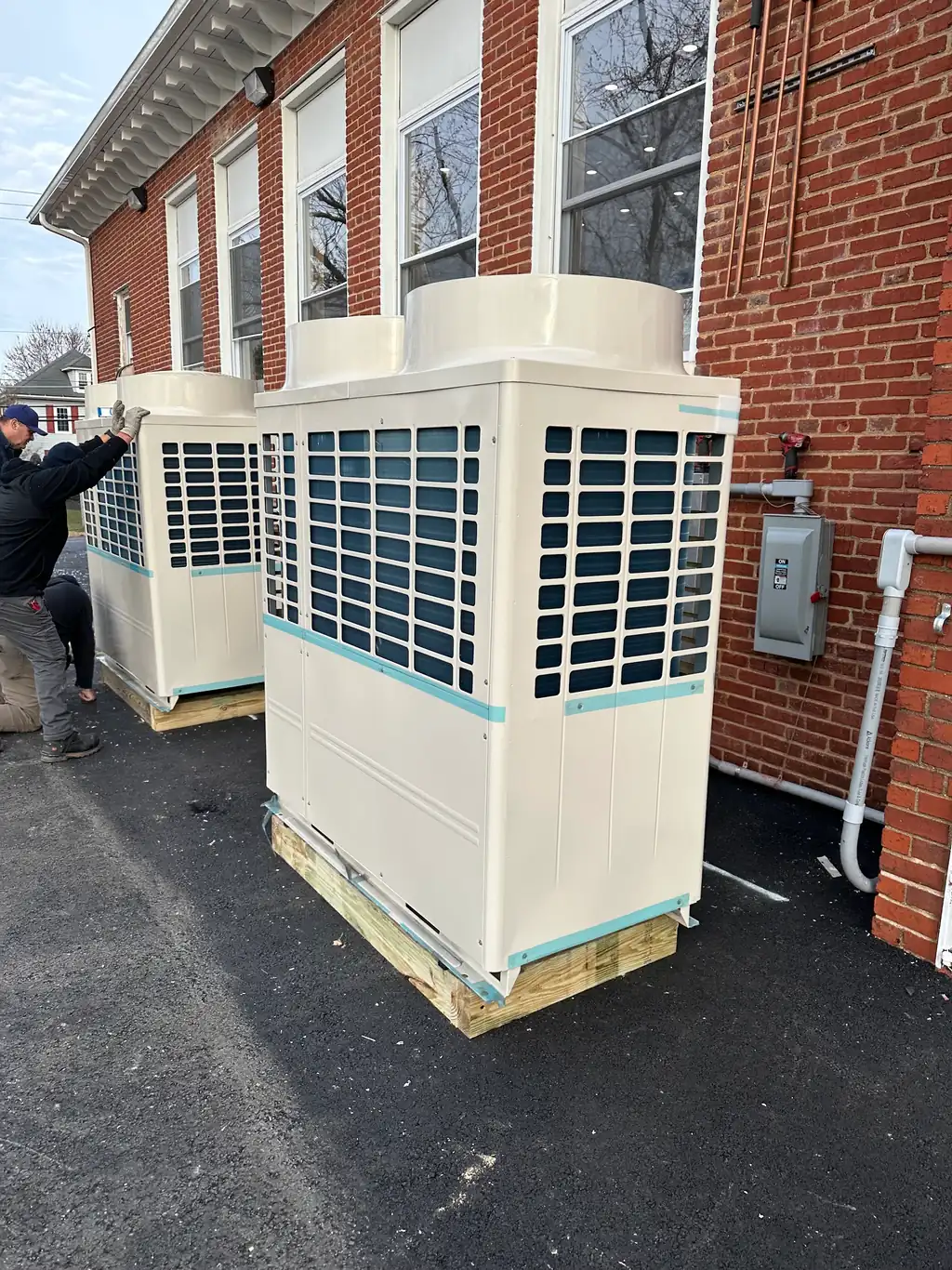 Commercial VRV outdoor units on a wood crib at a South Jersey building